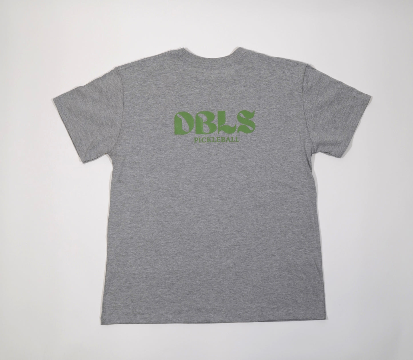 DBLS pickleball on the back of a grey oversized tee in the center