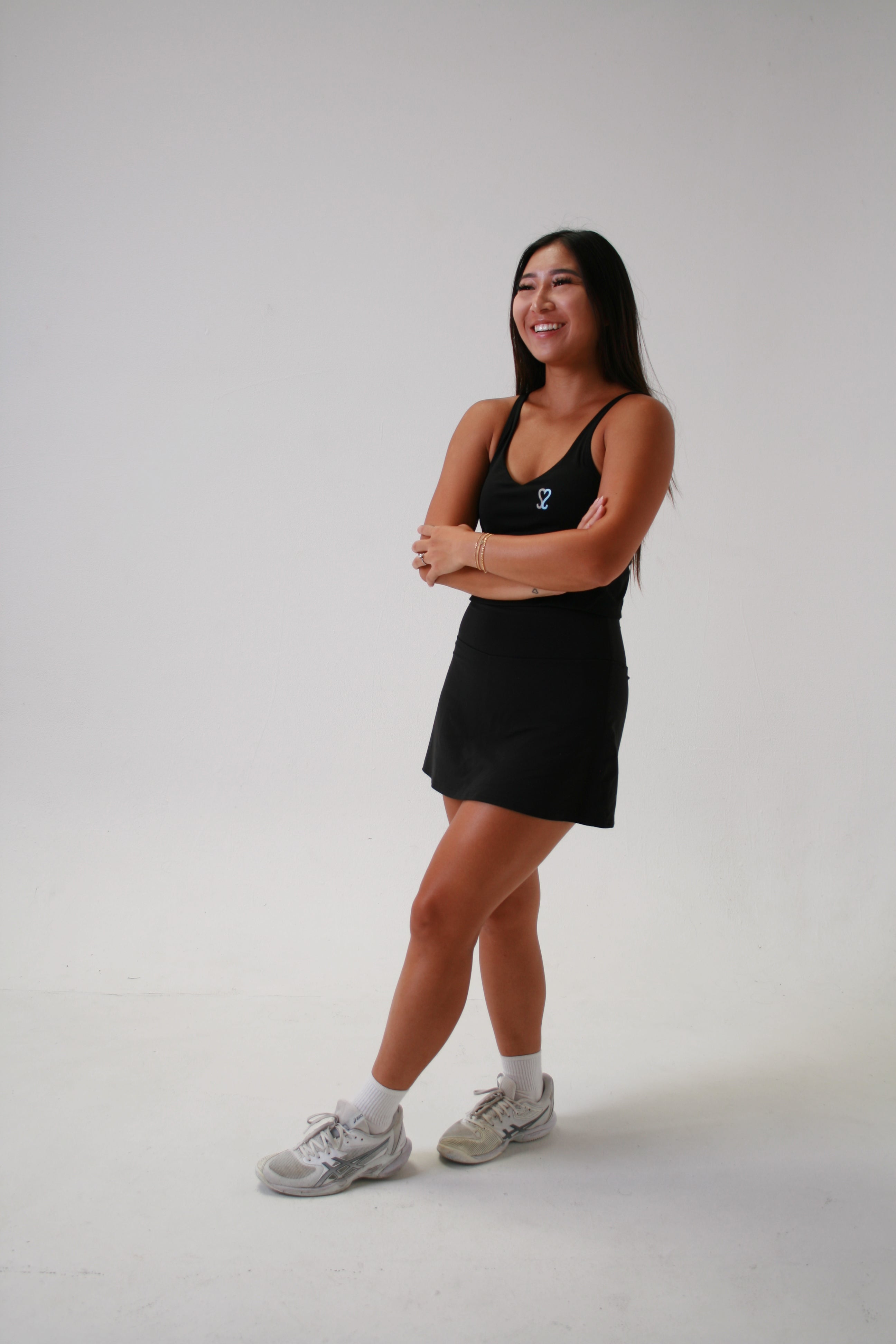 Stacey smiling posing wearing the black ssnap tank 