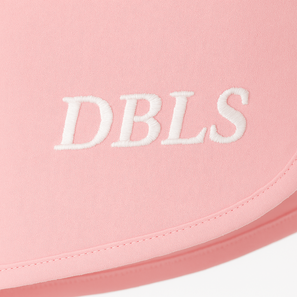 Pink fabric with 'DBLS' embroidered in white on a white background