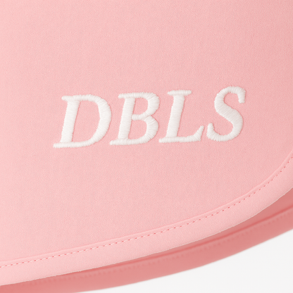 Pink fabric with 'DBLS' embroidered in white on a white background